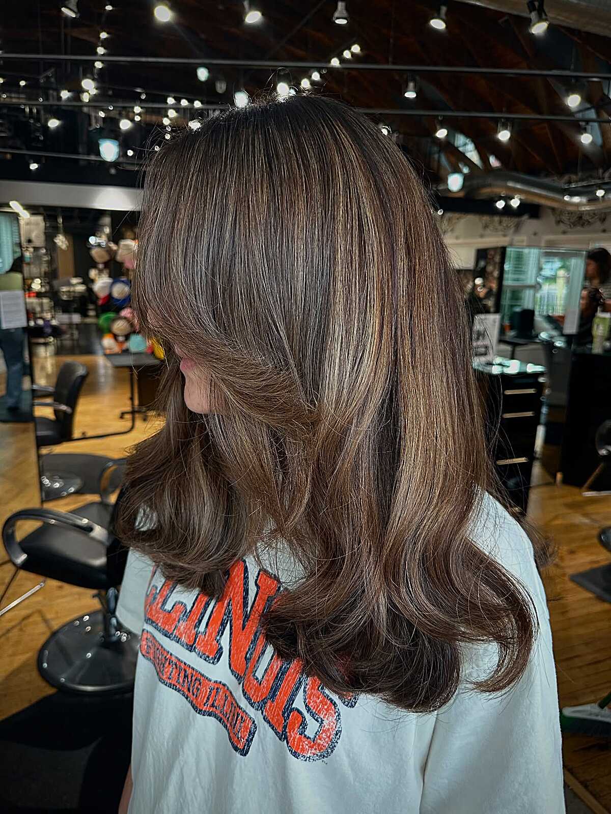 Medium brunette with warm highlights and layered ends