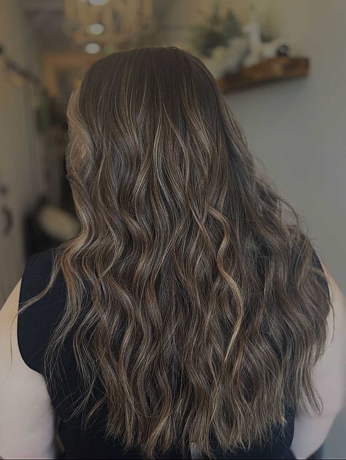Long cool-toned brunette waves with subtle ash highlights