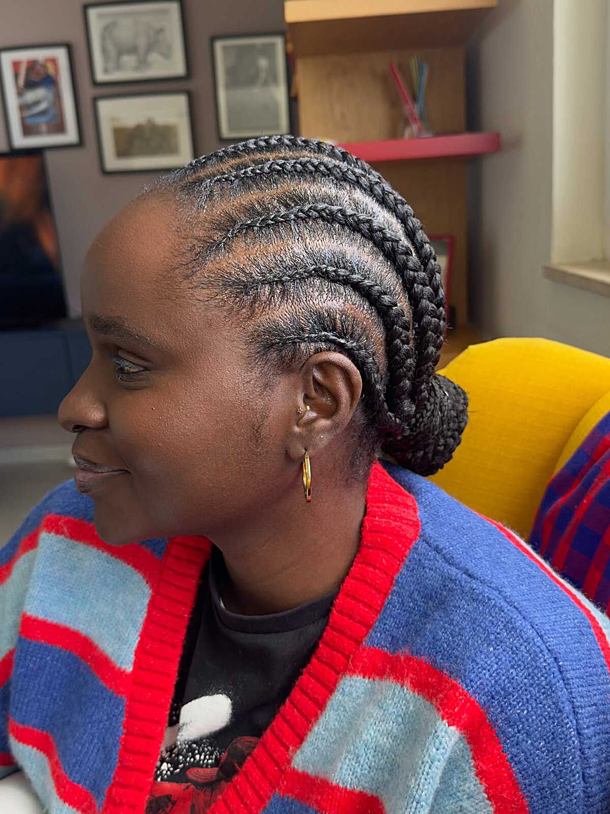 Straight-back cornrows gathered into a low bun