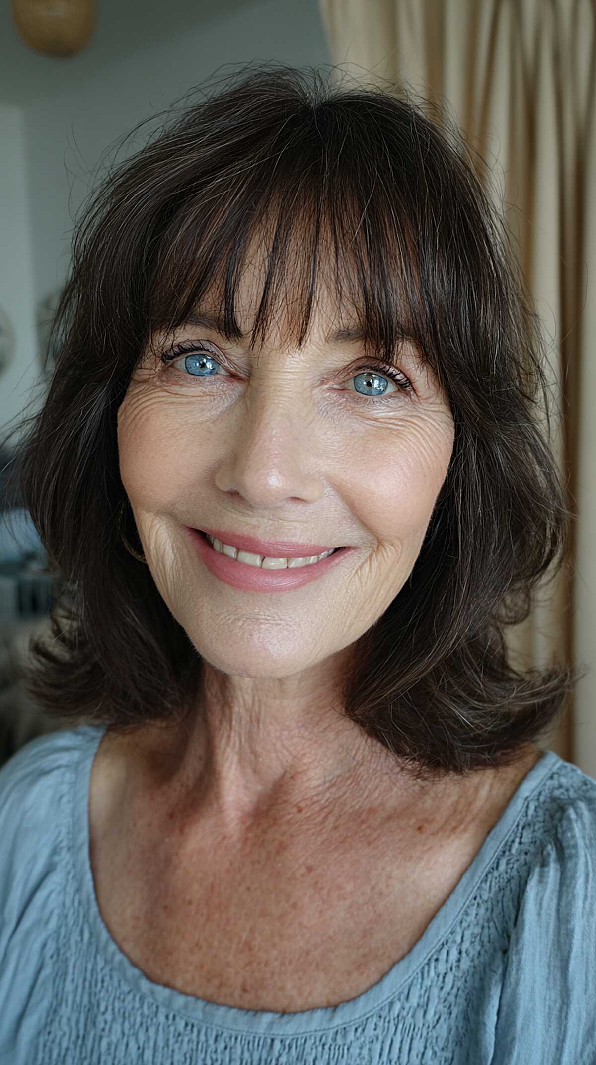 Dark brunette shoulder-length shag with feathered bangs