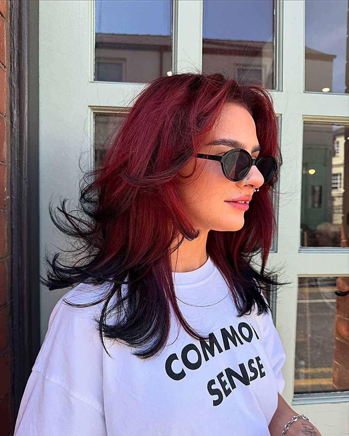 Deep cherry red layered hair with flipped ends