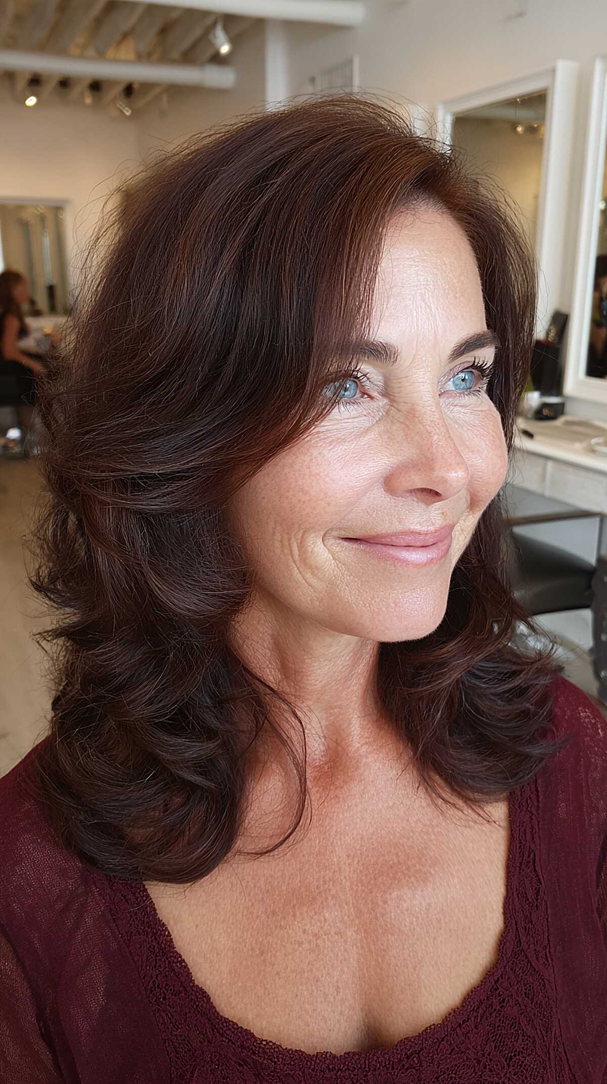 Deep mocha brunette blowout with curtain layers