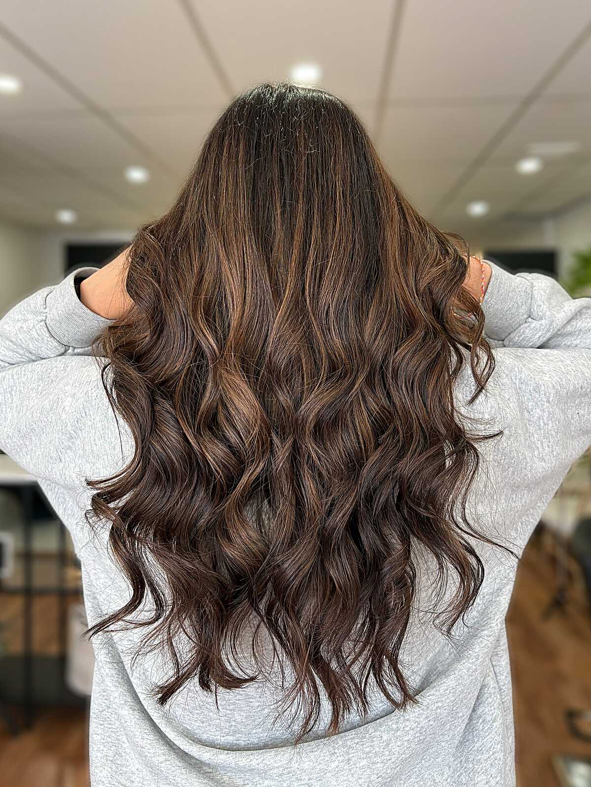 Long wavy deep mocha brunette with caramel highlights