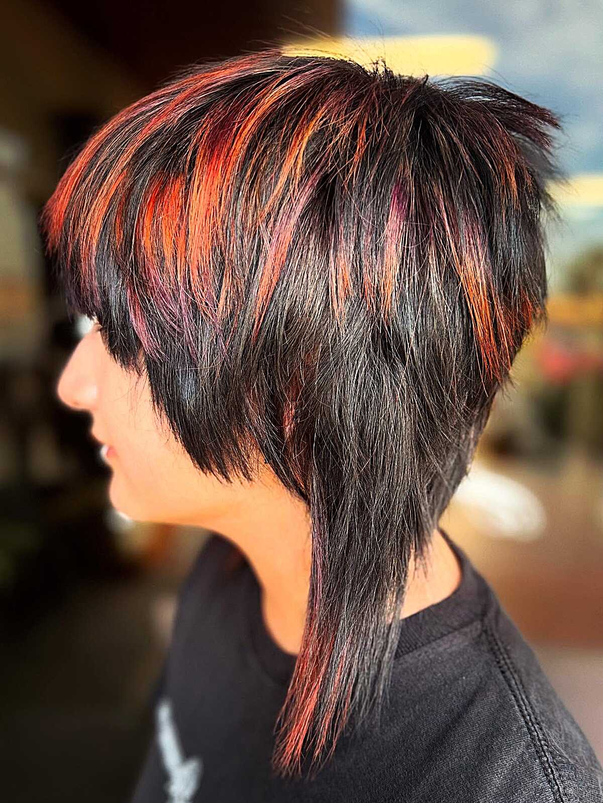Stacked black pixie with red and orange streaks