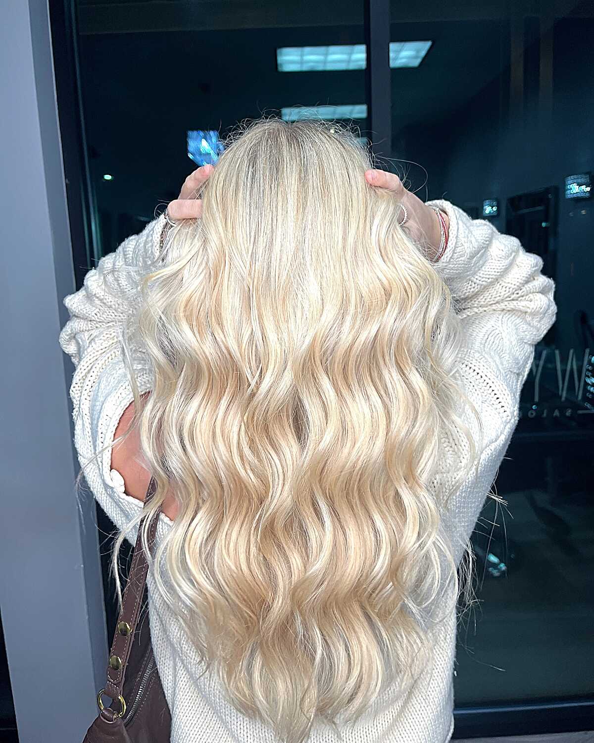 Long wavy vanilla blonde hair with creamy all-over color
