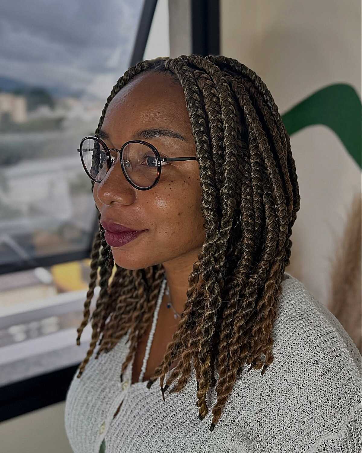 Chin-length honey blonde and brown bob twists