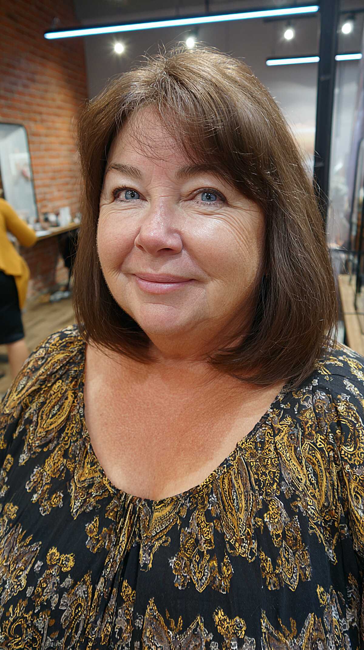 Medium brown longer layered bob with wispy side bangs