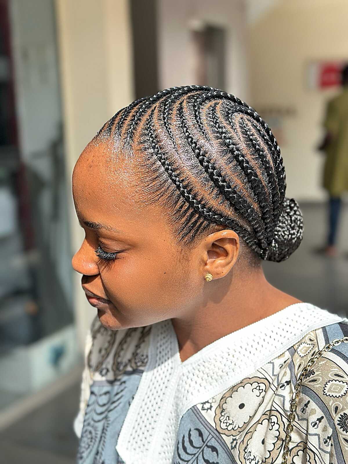 Micro cornrows braided back into a small low bun