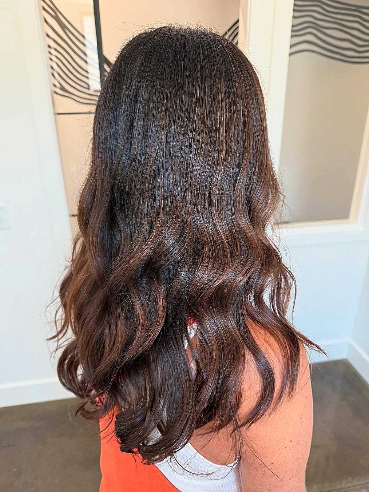 Long near-black brunette waves with subtle warm undertone