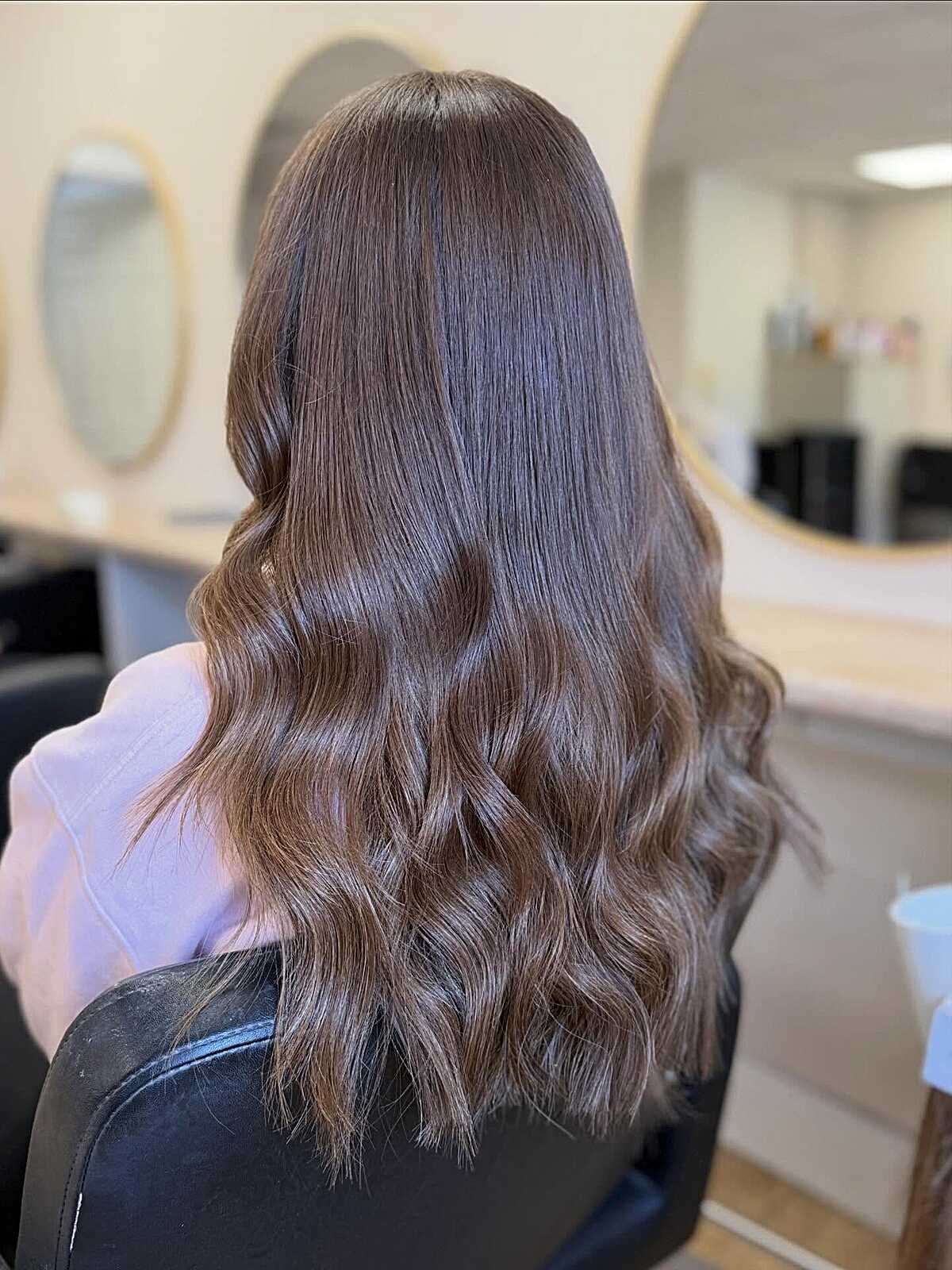 Smooth neutral milk chocolate brunette with bouncy waves