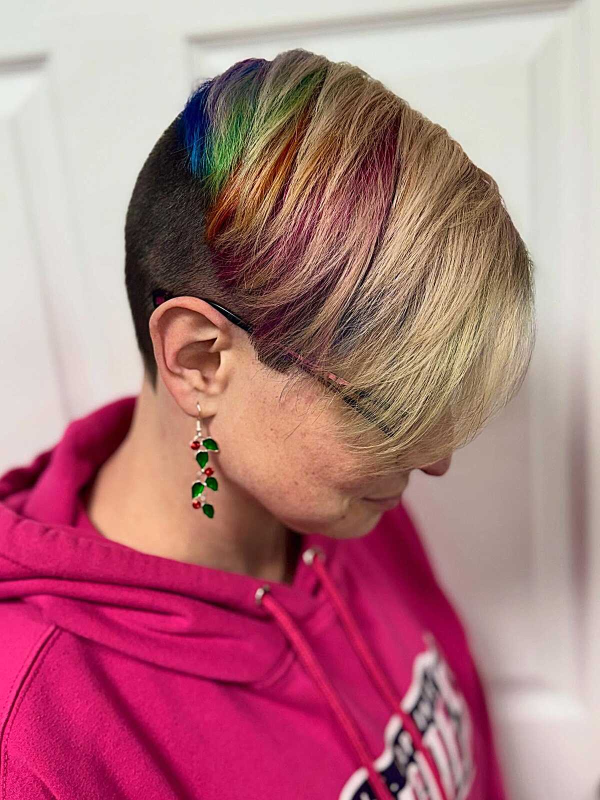 Blonde undercut pixie with rainbow color at the part