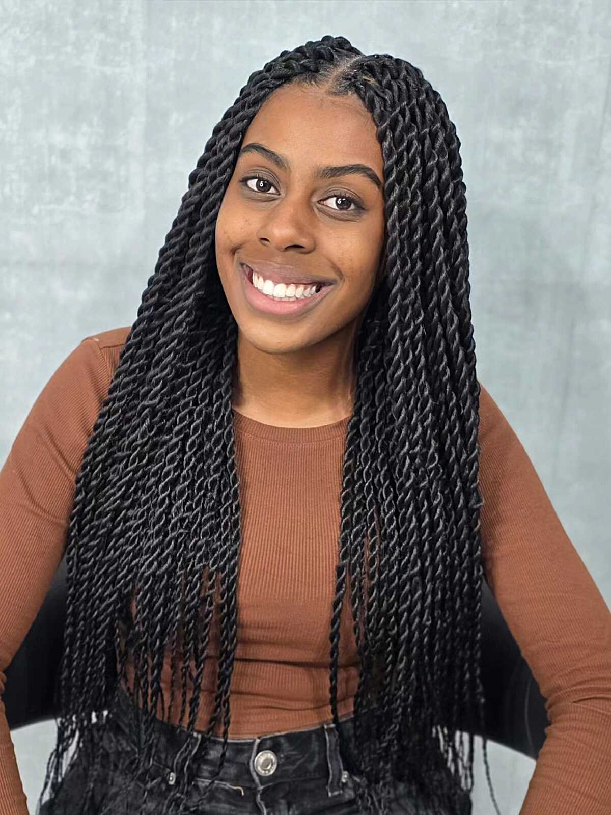 Medium black Senegalese twists with center part