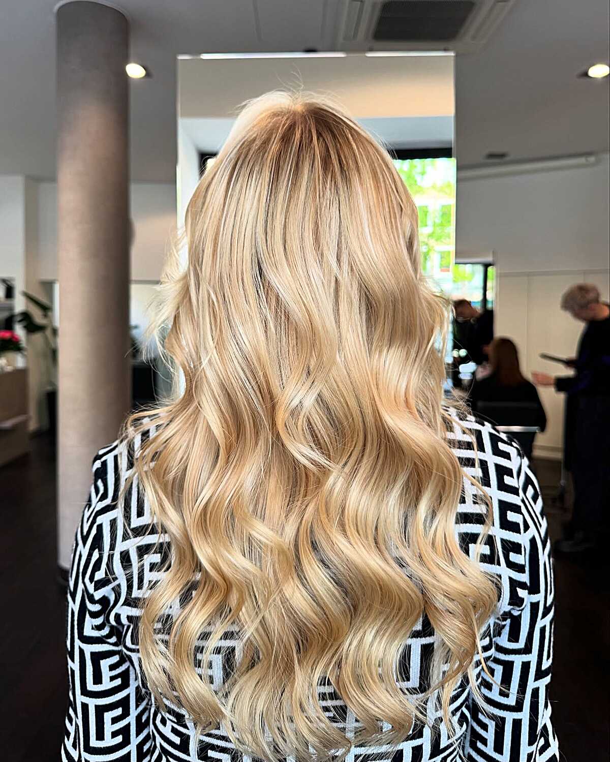Long polished honey blonde with bouncy salon-styled curls