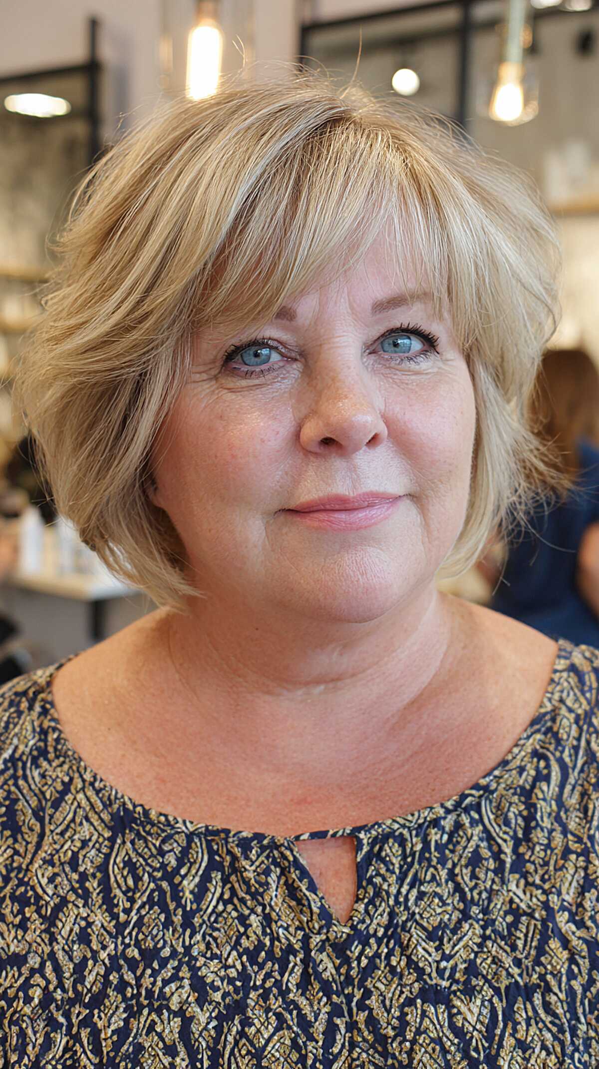 Sandy blonde short layered bob with wispy fringe