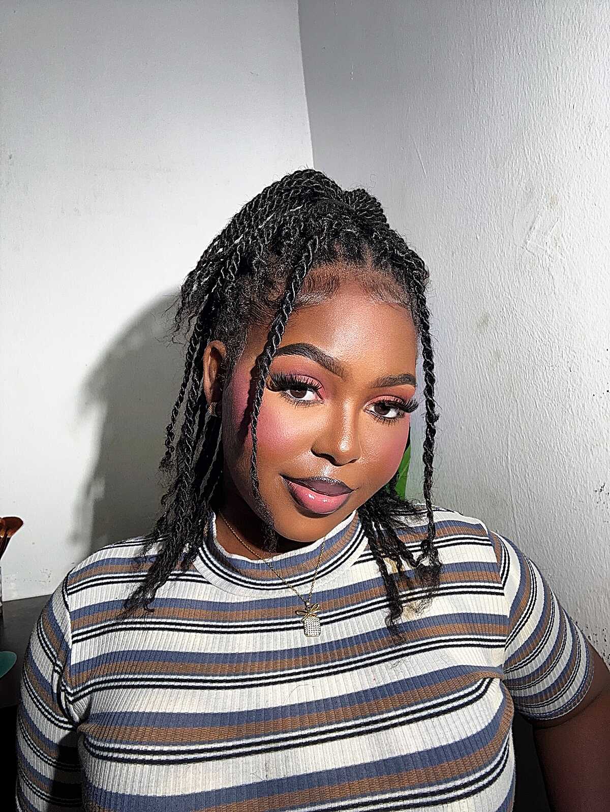 Shoulder-length black two-strand twists with side part