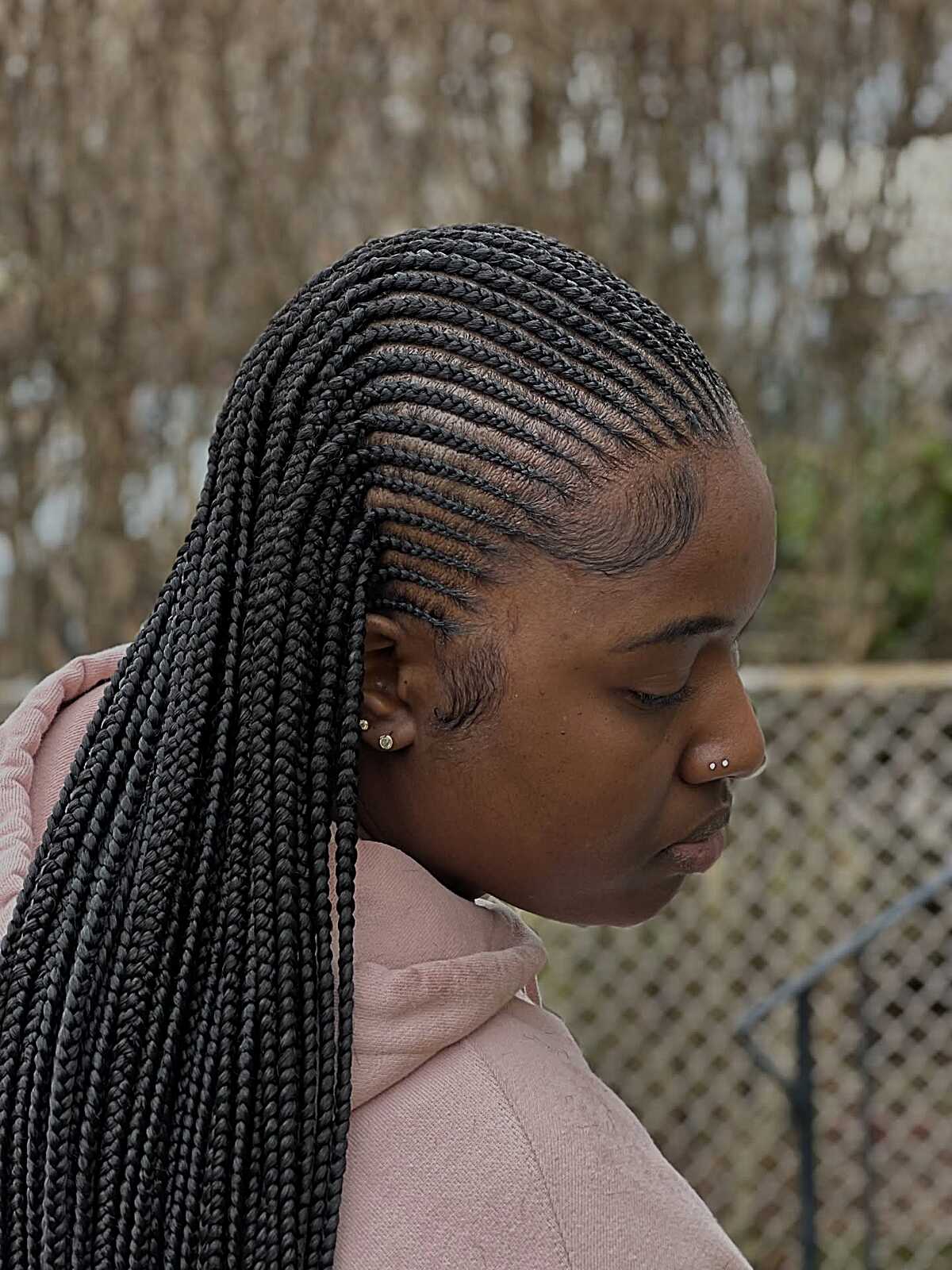 Side-swept black feed-in cornrows with box braids