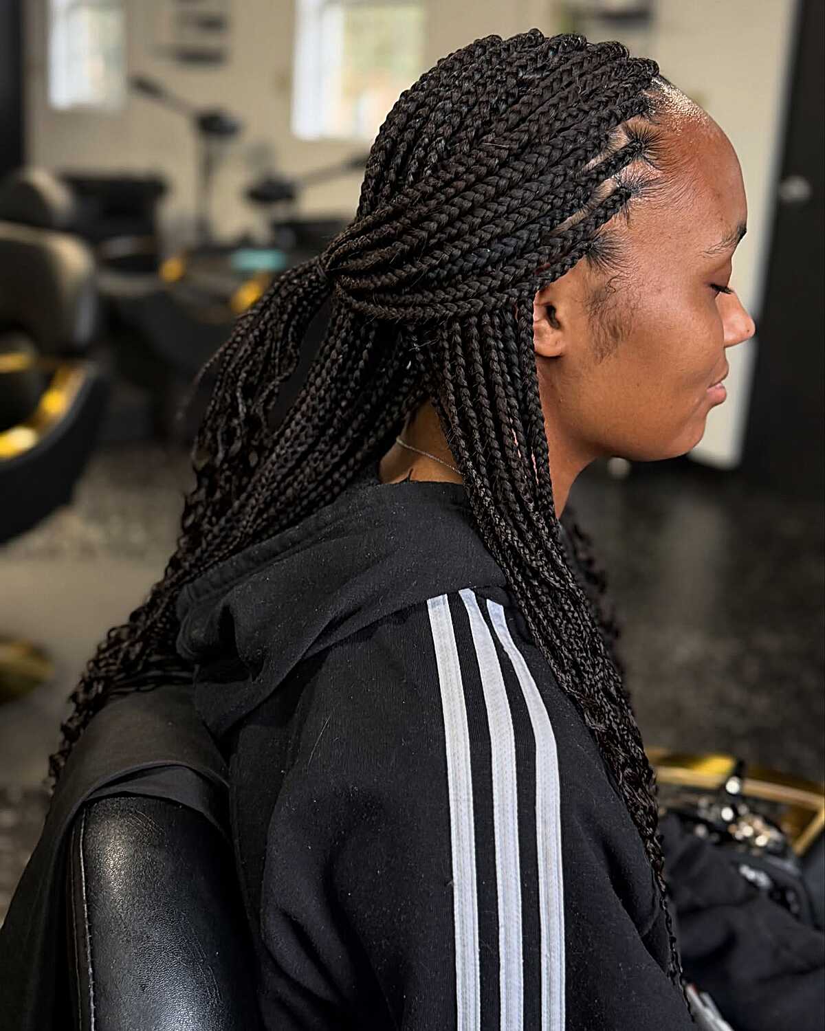 Small black box braids with clean center part