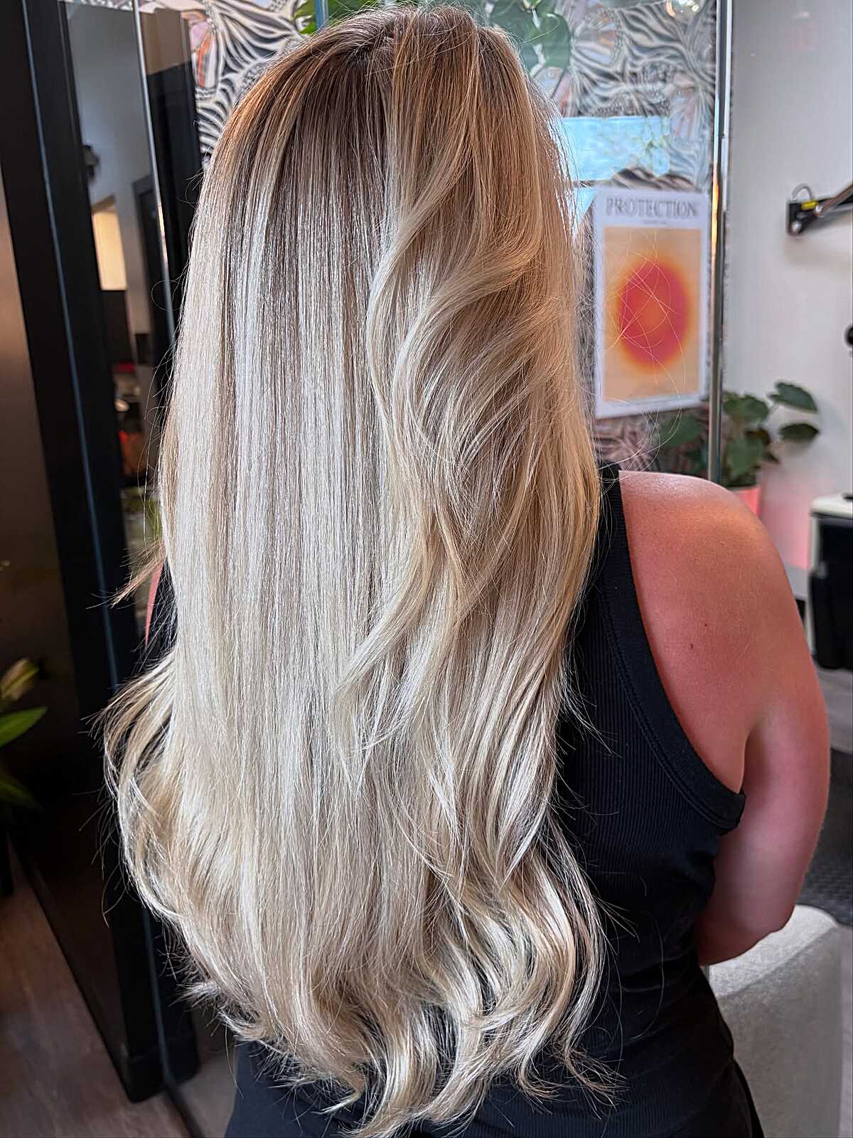 Long straight platinum blonde ombre with warm roots