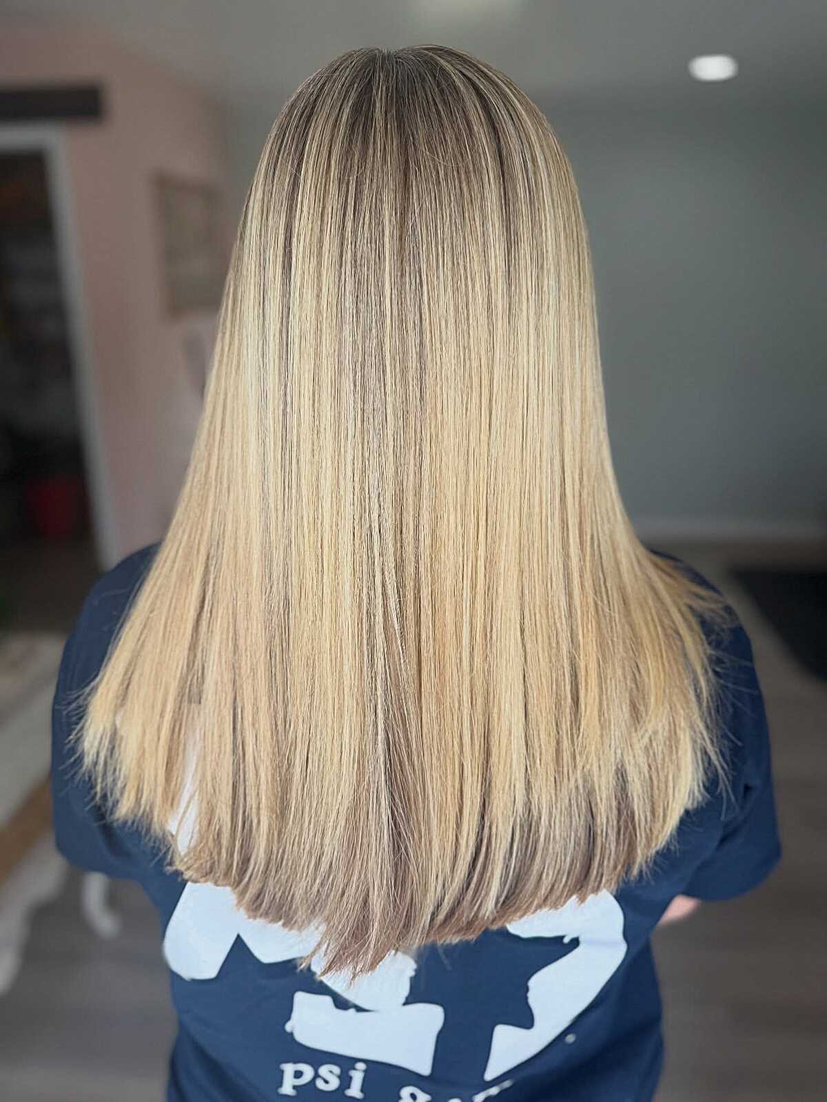 Mid-length sleek straight caramel blonde with blunt ends