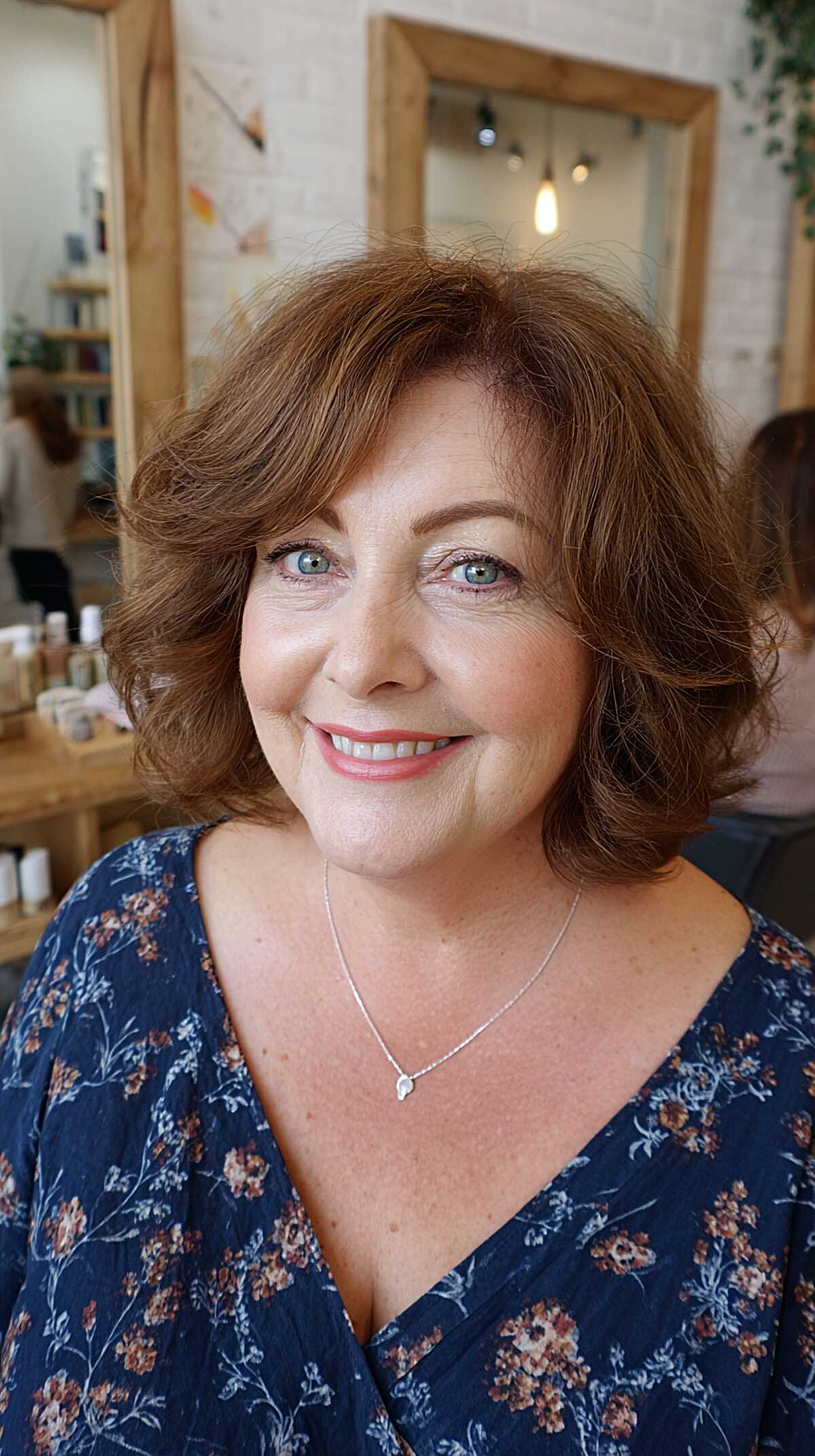 Soft auburn wavy layered bob with center part