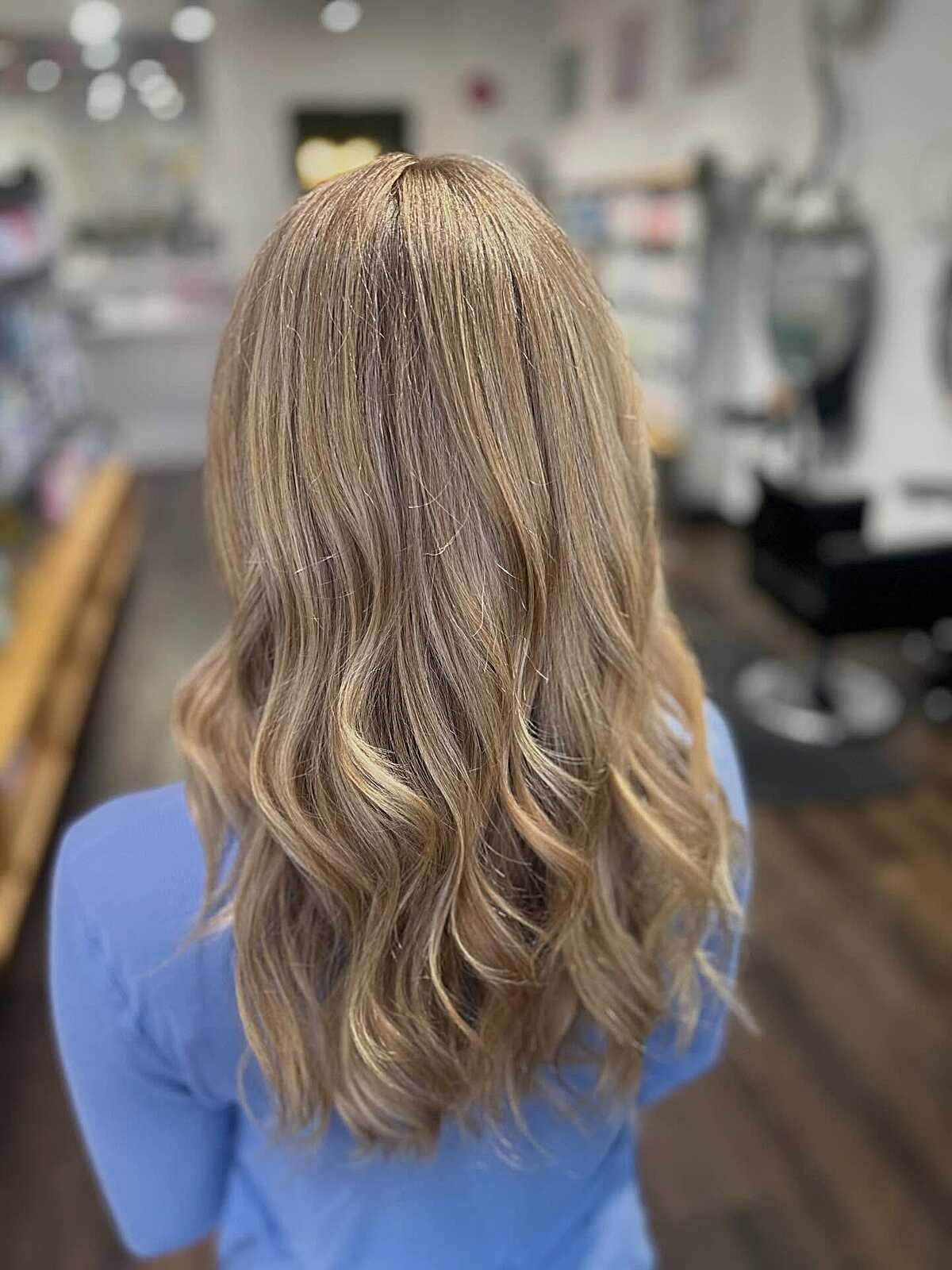 Medium length soft bronde with curled ends and warm glow
