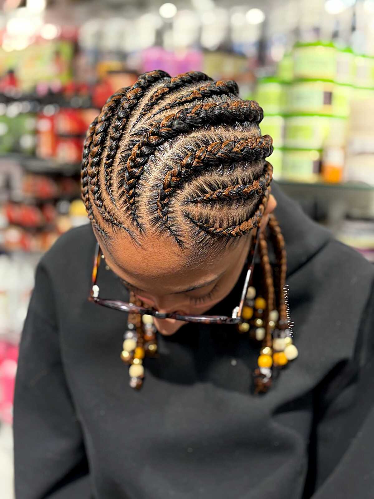 Spiral cornrow updo with beads hanging at front