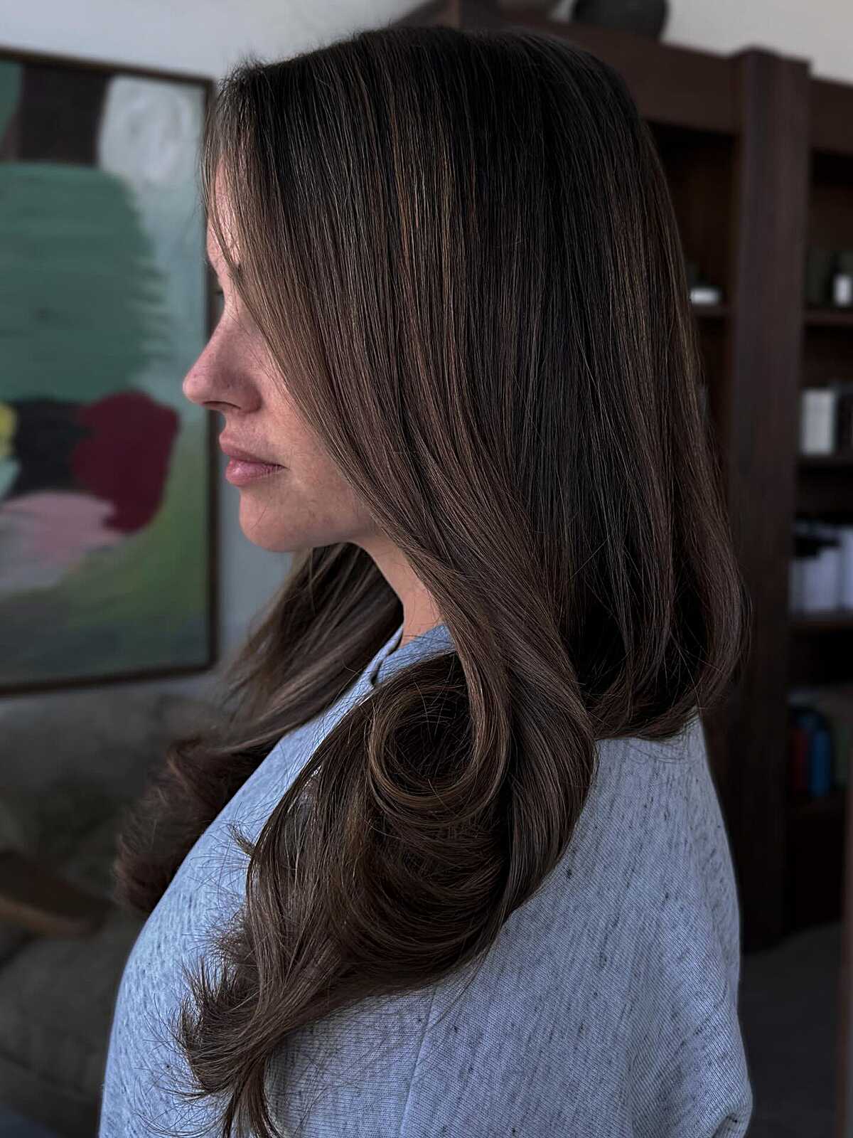 Medium brunette with soft chestnut tones and curled ends