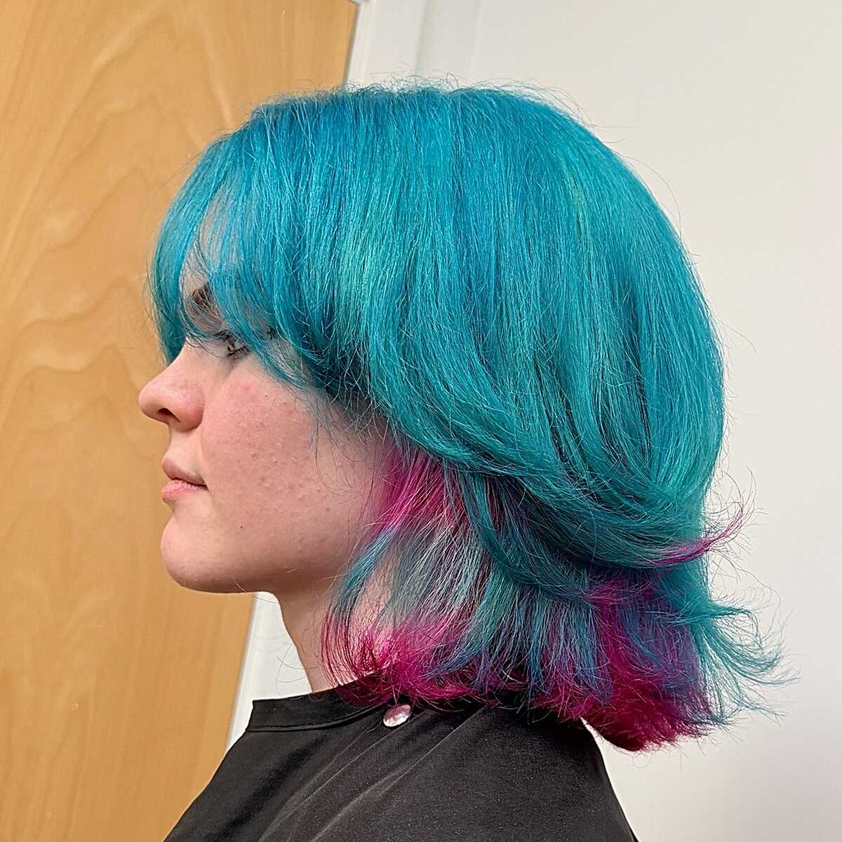Teal layered bob with fuchsia pink tips and bangs
