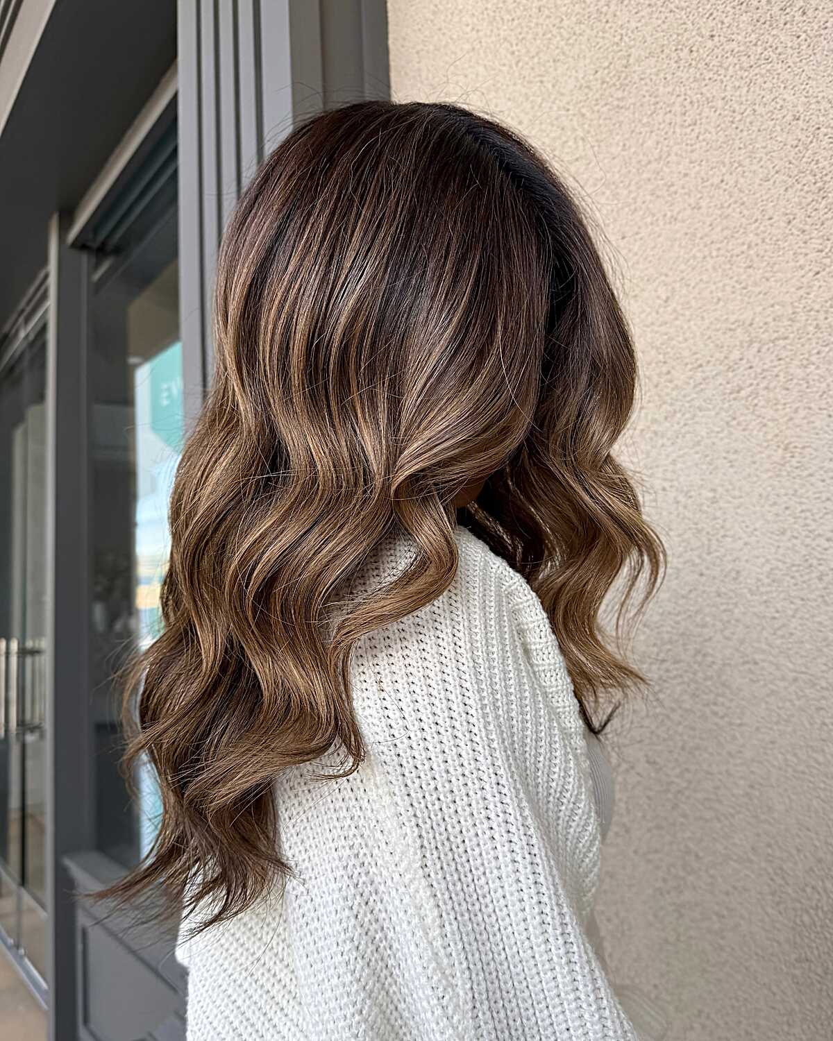 Medium-length brunette waves with toffee balayage