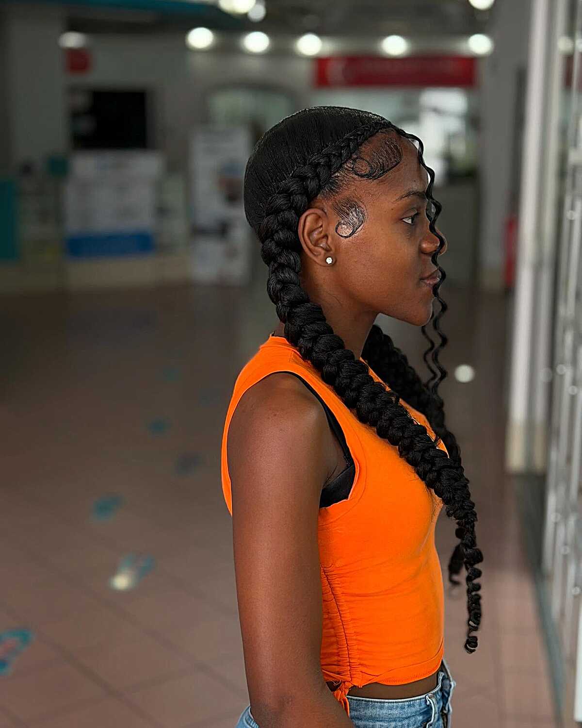 Two large feed-in braids with curled ends