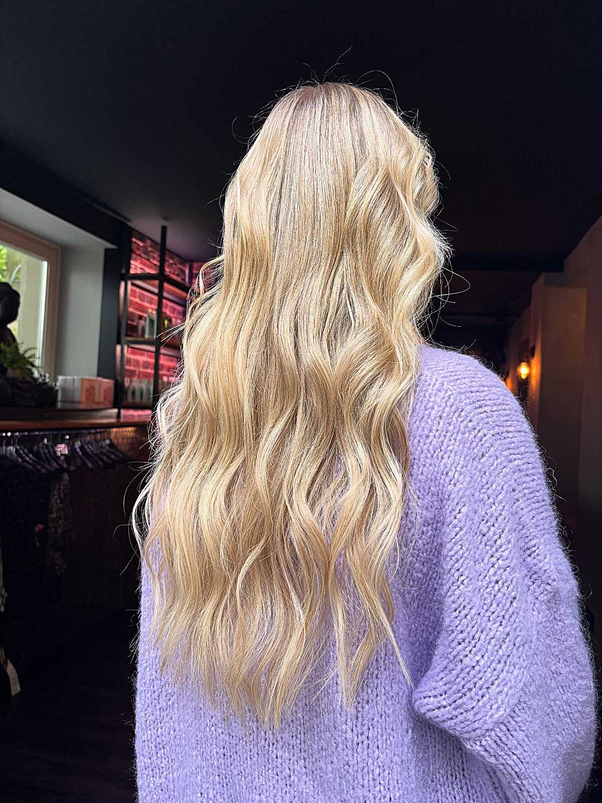 Long warm butter blonde with beachy waves and soft texture