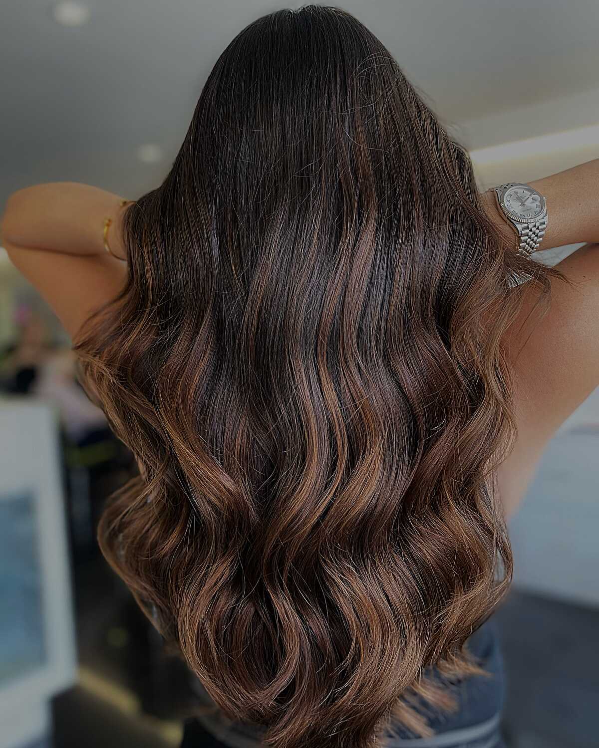 Dark brunette waves with warm caramel balayage highlights