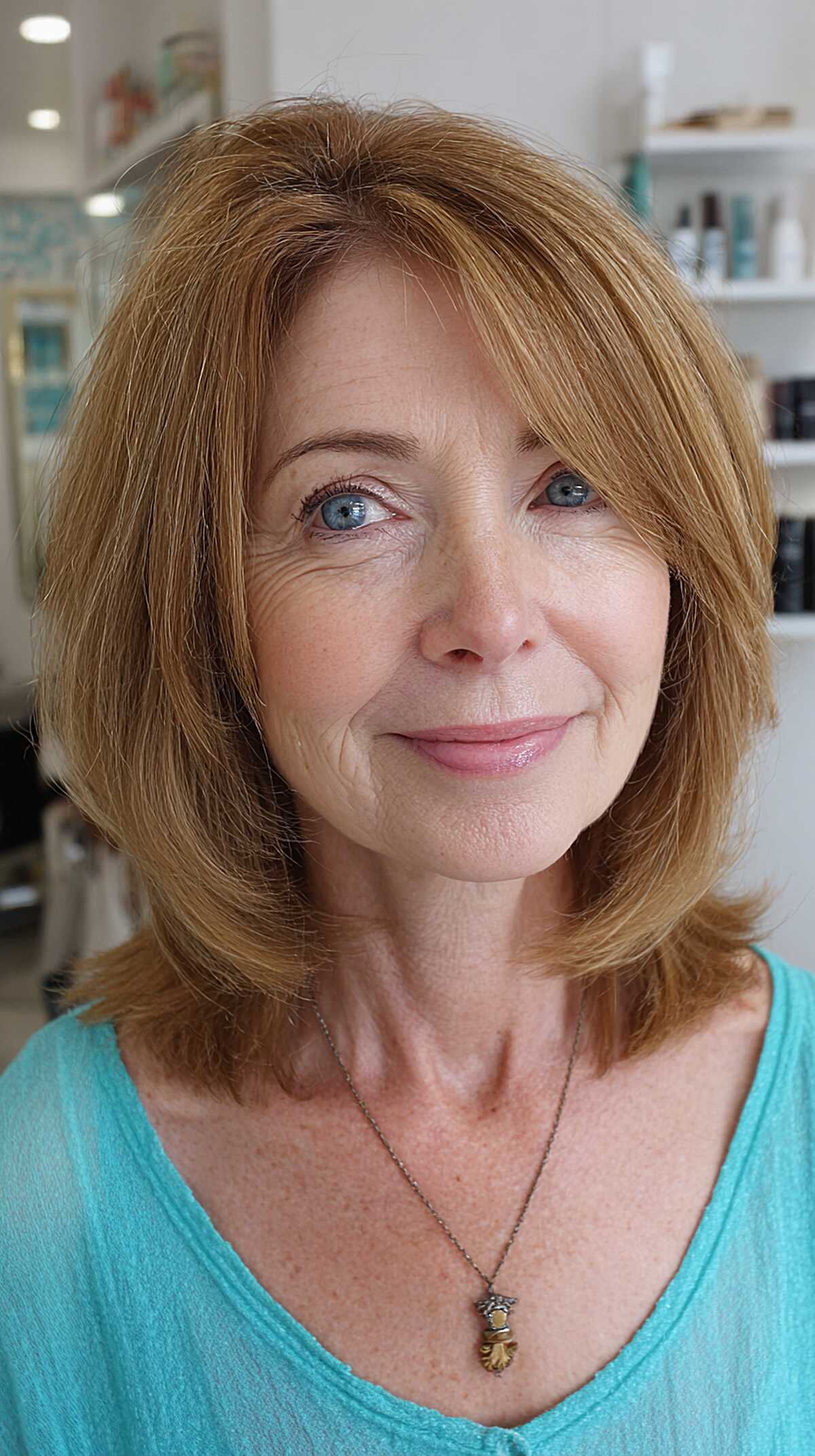 Warm strawberry blonde layered bob with soft volume