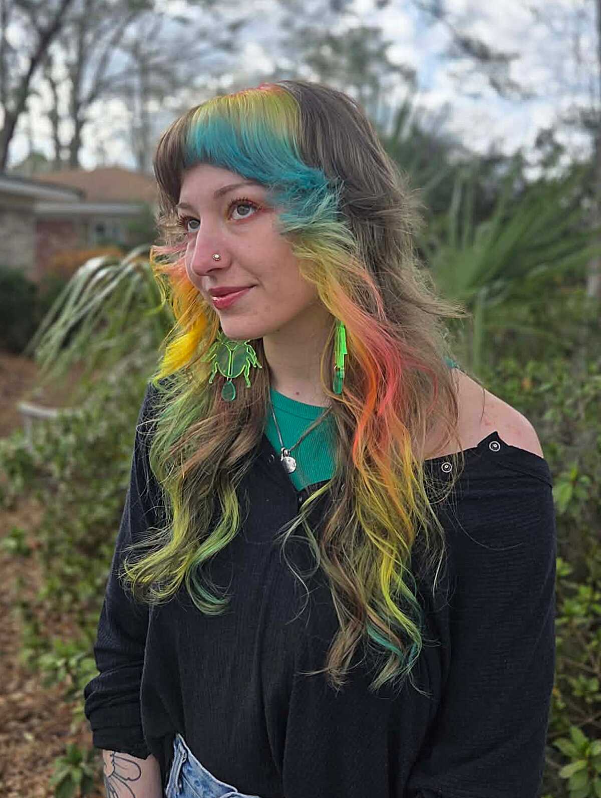 Long wavy hair with teal, yellow, and pink streaks