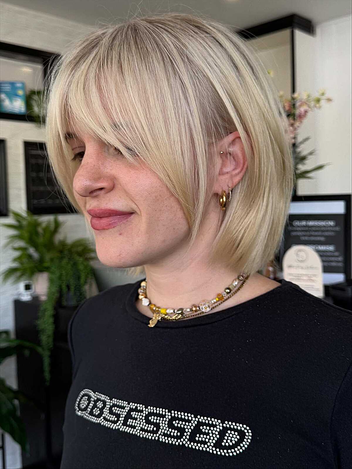 Platinum blonde chin-length bob with wispy bangs