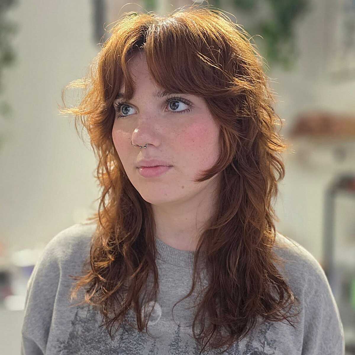 Warm copper wavy hair with lived-in shaggy bangs