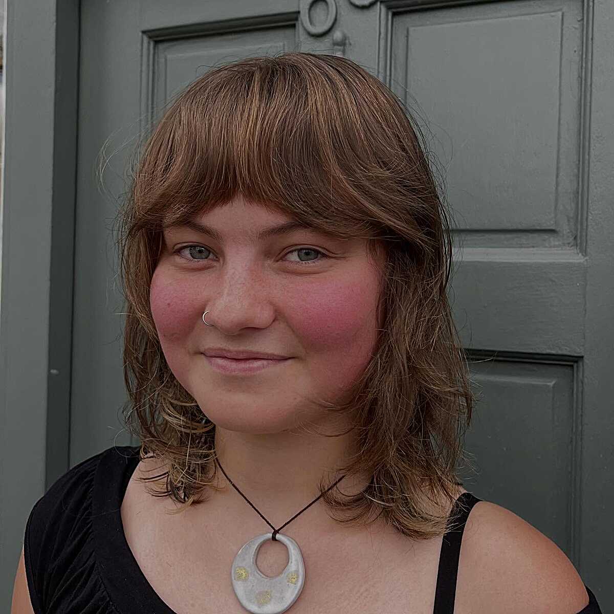 Warm copper shoulder-length shag with full bangs