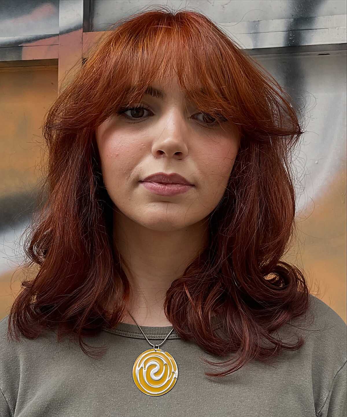 Deep red medium hair with bangs and vintage curled ends