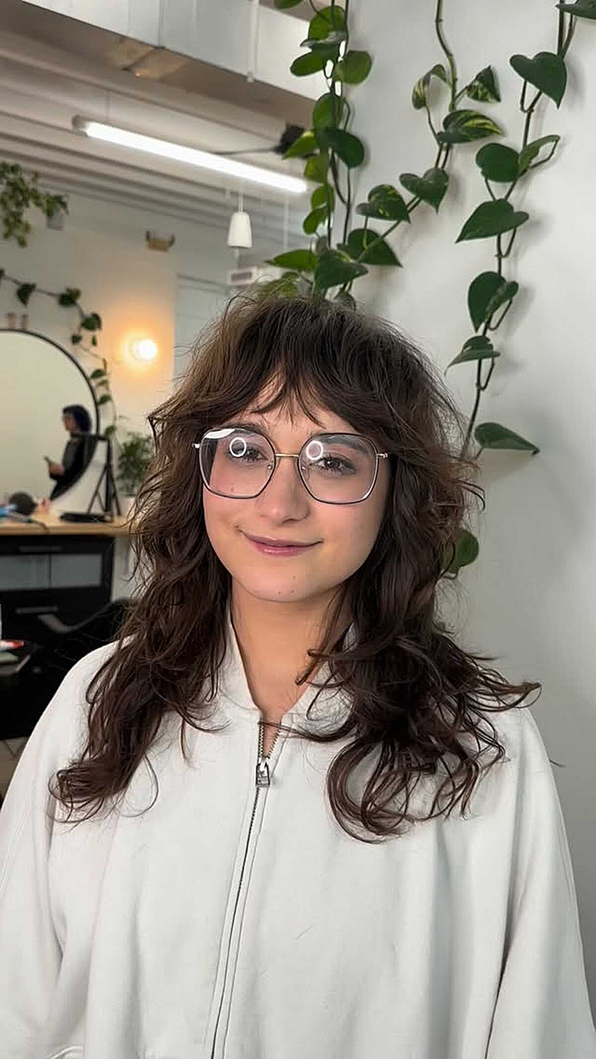 Brunette wavy hair with curly curtain bangs