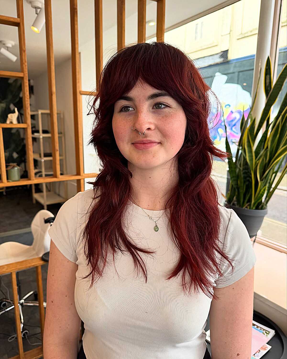 Dark burgundy long layers with wispy curtain bangs