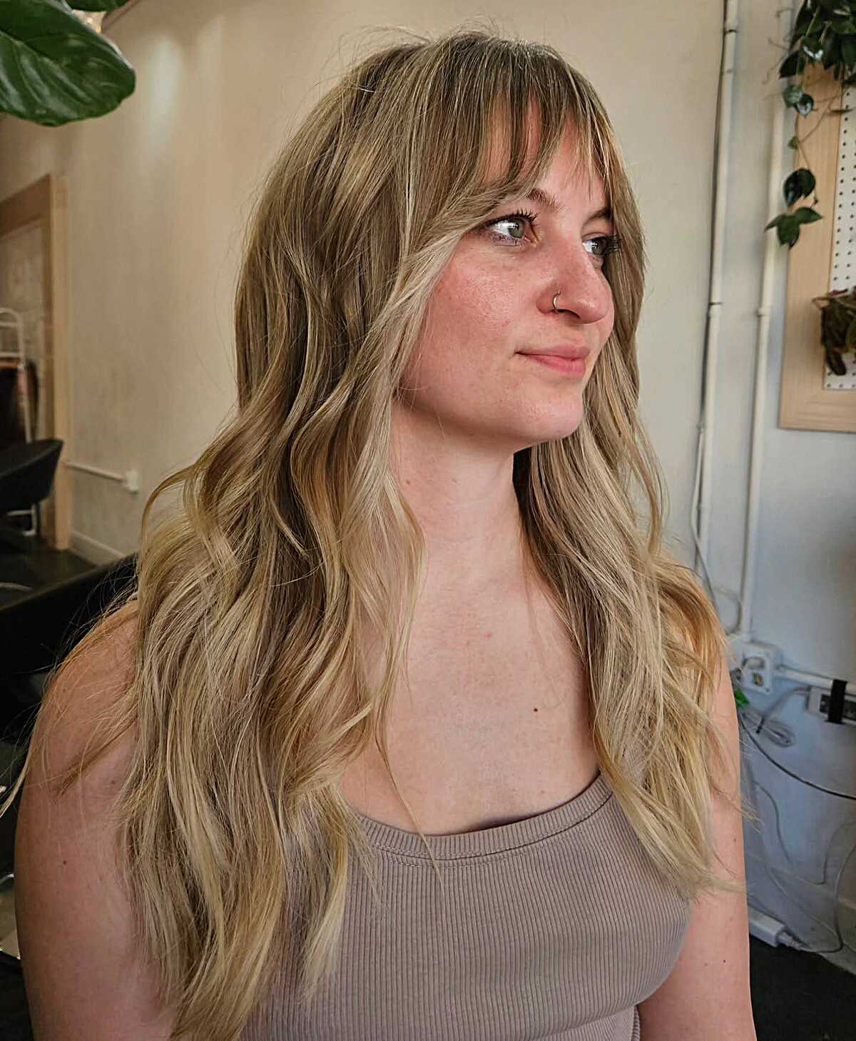 Dirty blonde long waves with thin wispy bangs