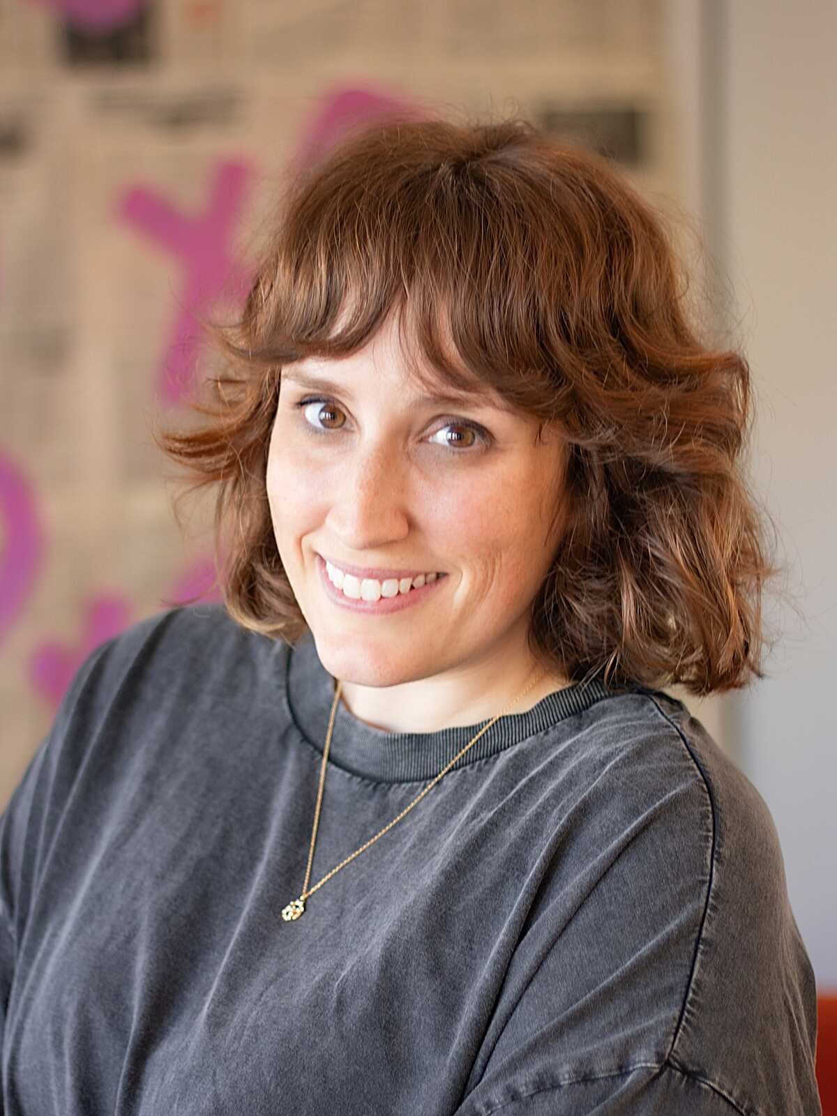 Warm auburn chin-length bob with curly bangs