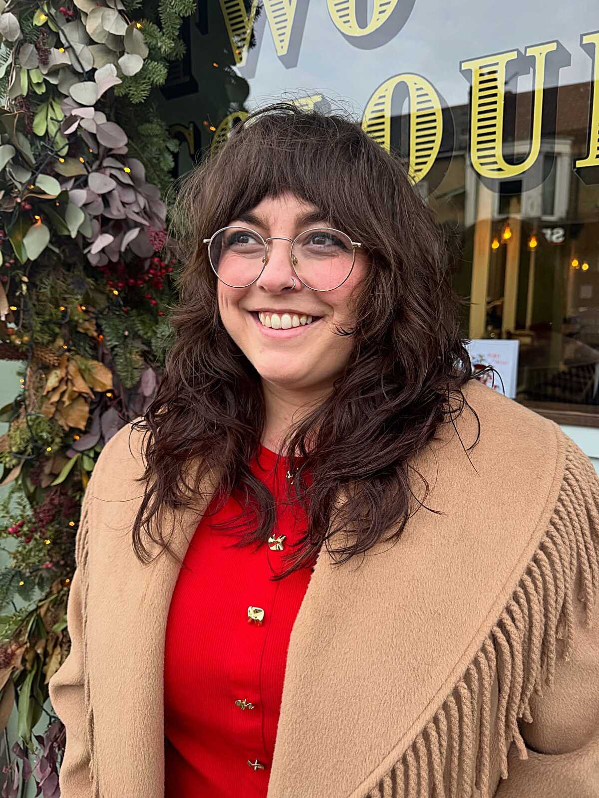 Dark wavy shag with bangs and round glasses