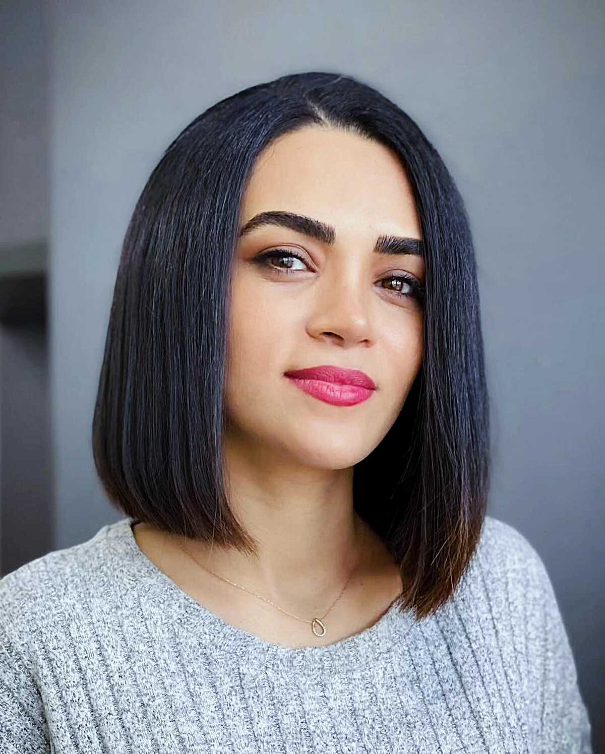 Sleek blunt dark lob with center part and shine