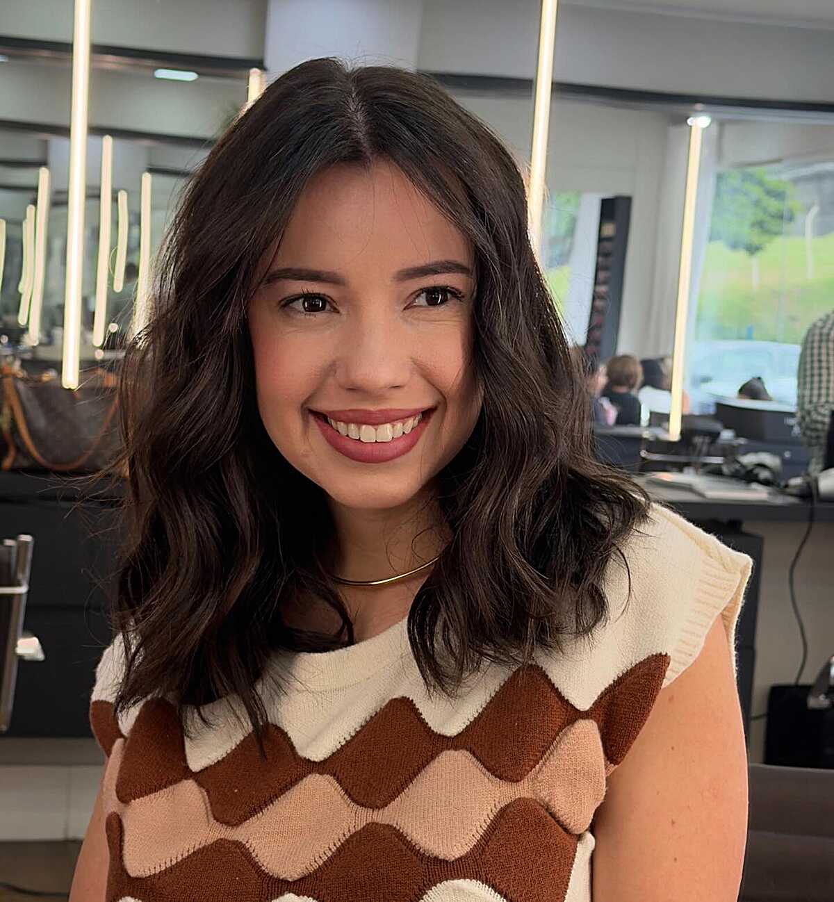 Bouncy dark brown wavy lob with center part