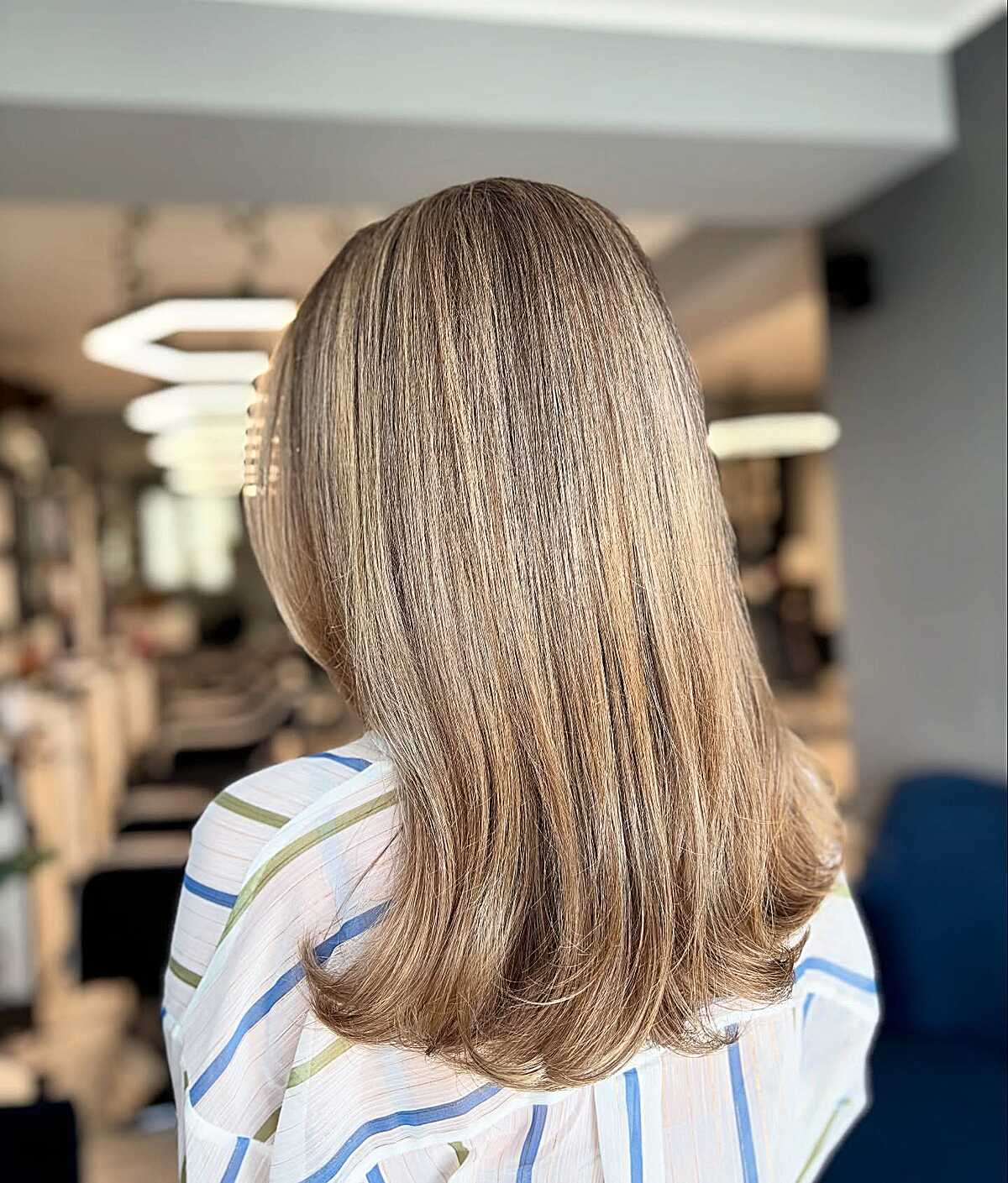 Sleek medium-length cinnamon brown balayage lob