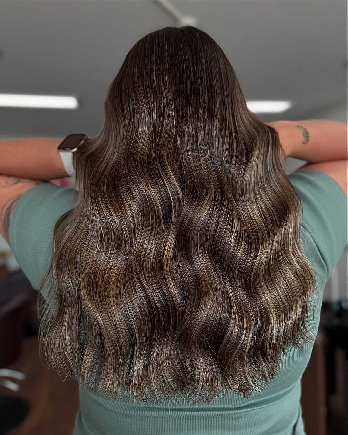 Medium brown hair with cool-toned mushroom balayage waves