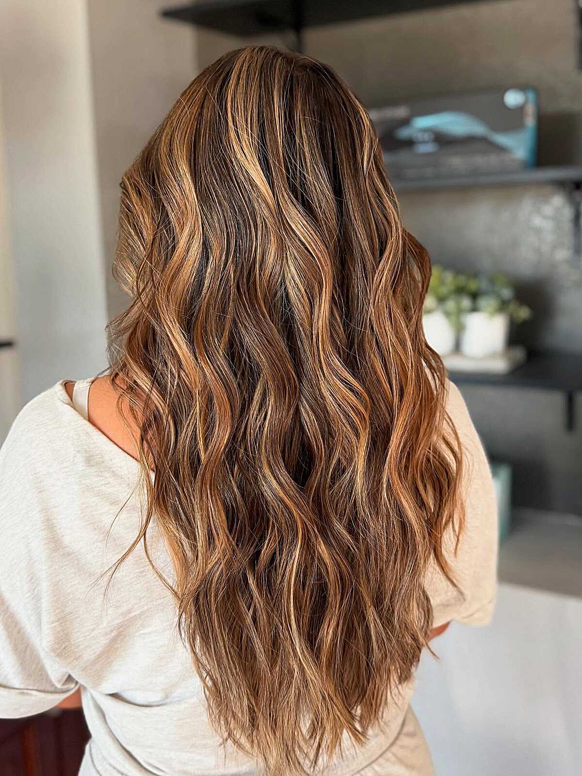 Long wavy hair with copper and caramel balayage pieces