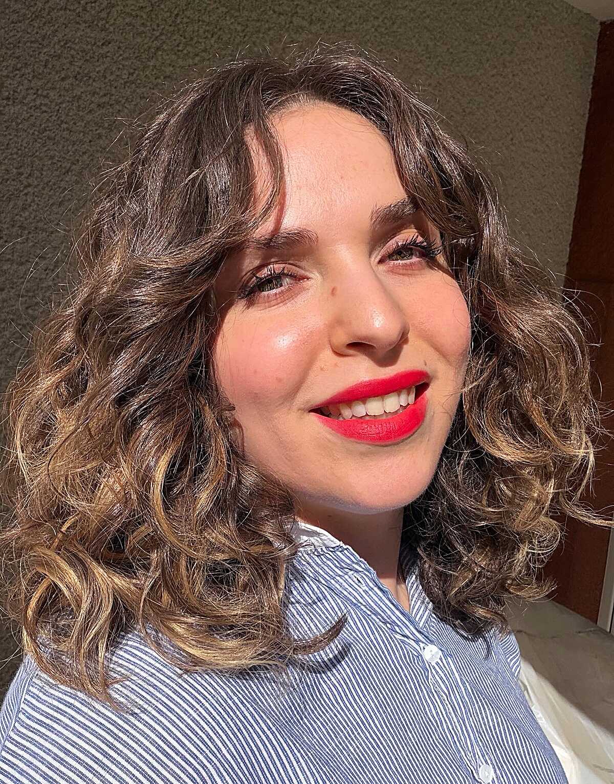Curly brown lob with natural texture and highlights
