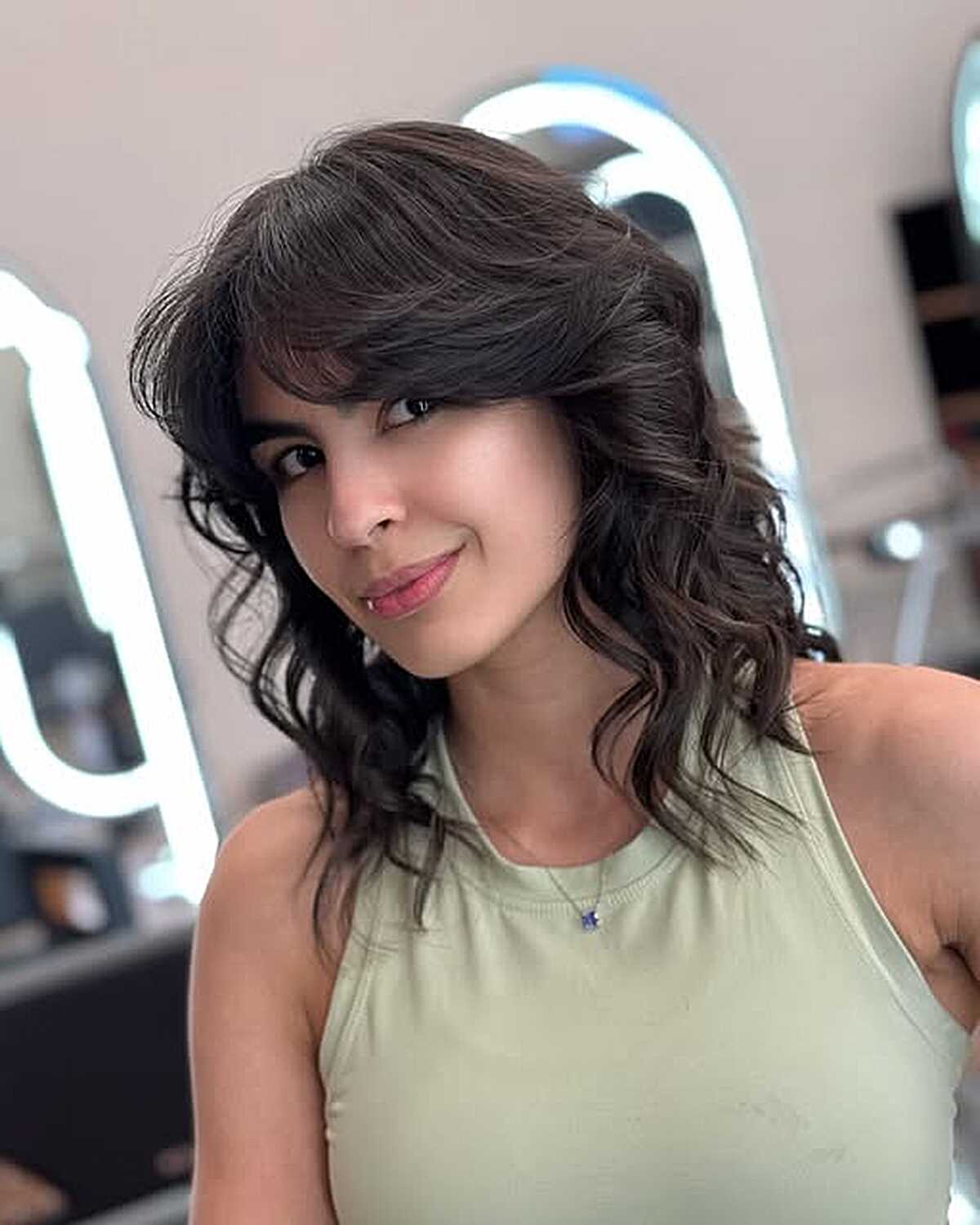 Curly dark brown shag lob with wispy bangs